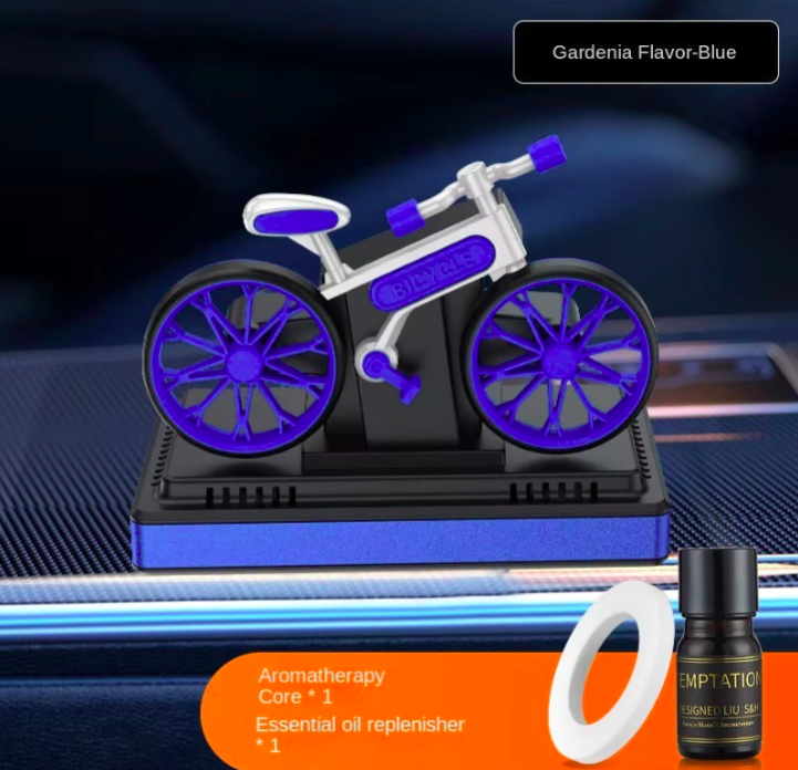 Bicycle-shaped aroma diffuser with essential oil bottle on a dark background