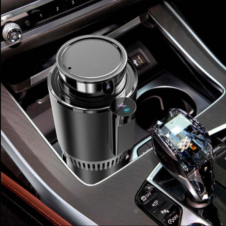 Black car cup holder with a coffee cup and smartphone inside a car console.
