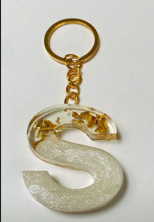 Keychain with a letter 'S' design on a light gray background