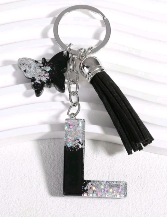 Keychain with butterfly, letter 'L', and tassel on a white background