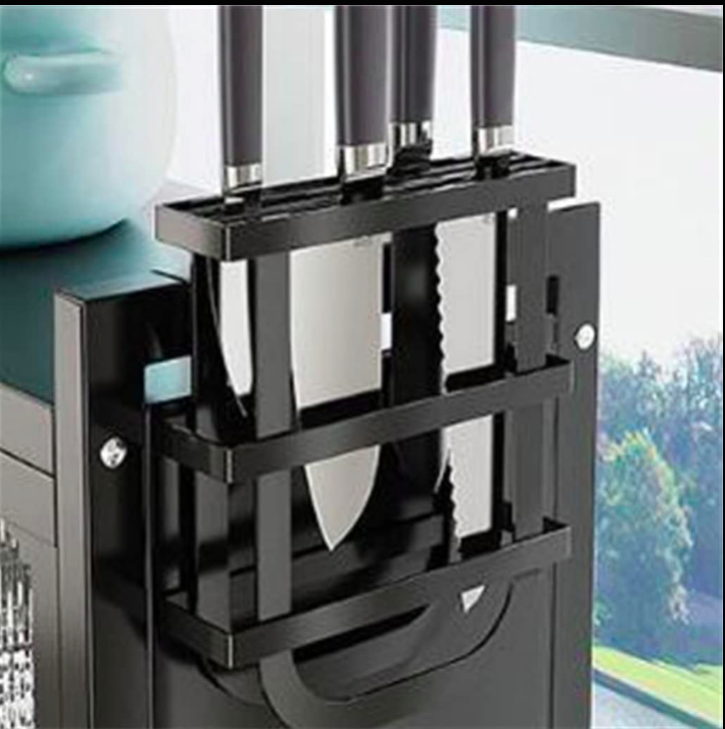 Black knife block with three knives on a kitchen counter