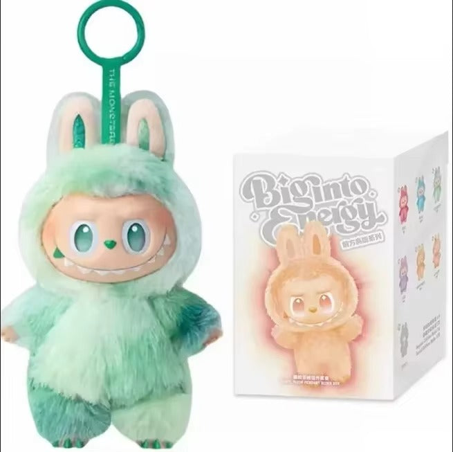 Plush toy in a green costume with a matching box on a white background