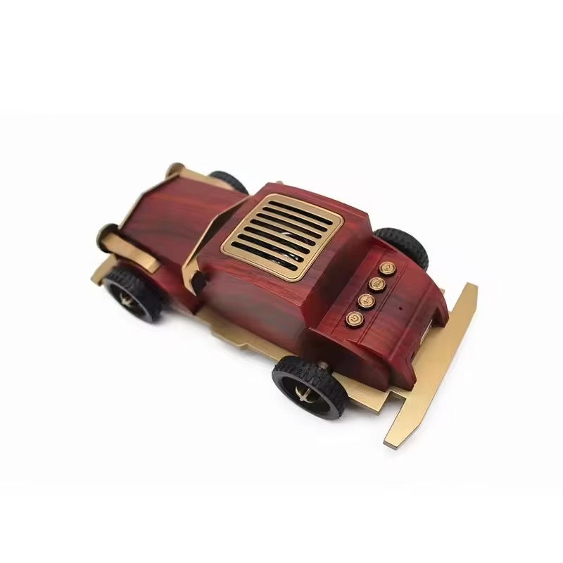 Wooden toy car with brass accents on a white background