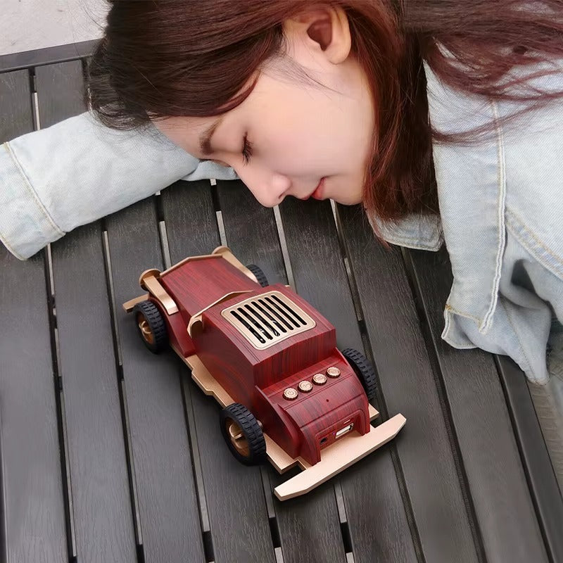 Woman looking at a wooden toy car on a wooden surface