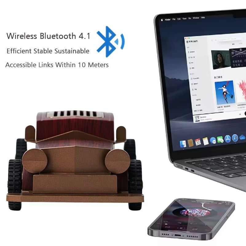 Cardboard model of a car with Bluetooth 4.1 technology displayed next to a laptop and smartphone.