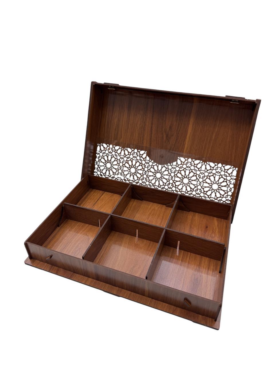 Wooden jewelry box with intricate cut-out design on a white background