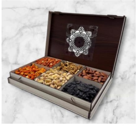 Open box of assorted dried fruits on a marble surface