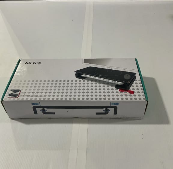 Black comb on a white box with visible brand name
