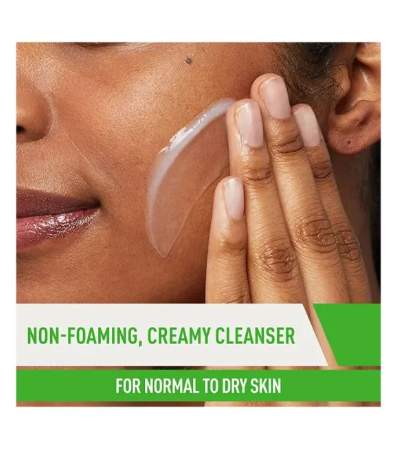 Person applying non-foaming, creamy cleanser to face with text indicating product use for normal to dry skin.