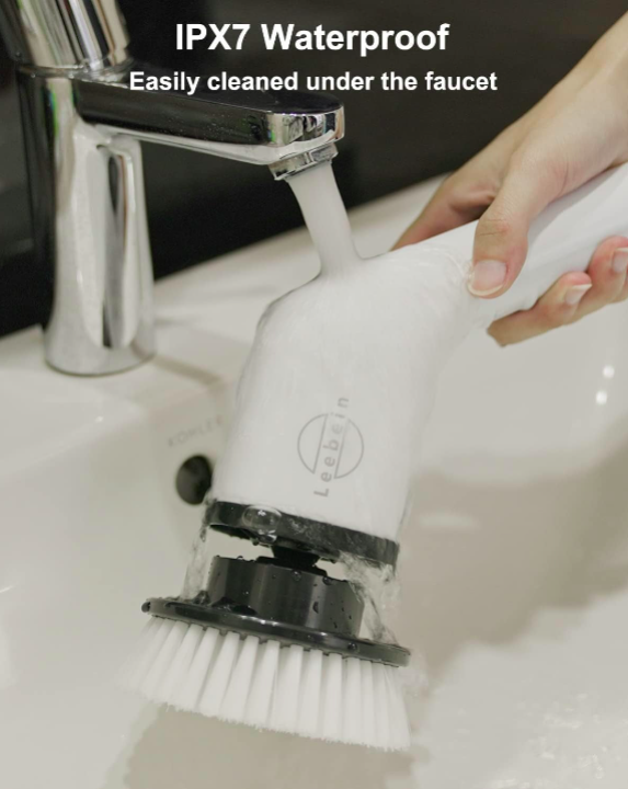 Cleaning brush with IPX7 waterproof label being rinsed under a faucet.