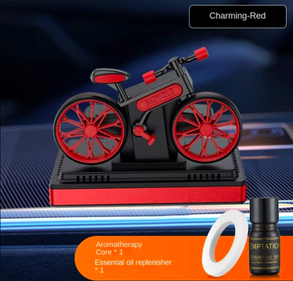 Motorcycle-shaped aromatherapy diffuser with a bottle and ring on a blue background