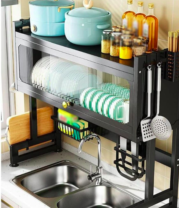 Kitchen sink area with a black dish rack, turquoise pots, and various kitchen utensils.