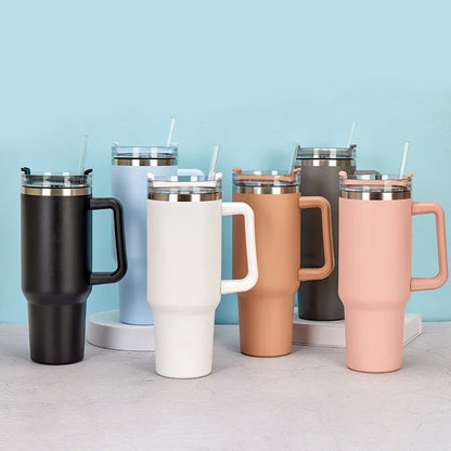 Set of colorful insulated travel mugs with handles on a light blue background