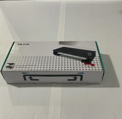 Black comb on a white box with visible brand name