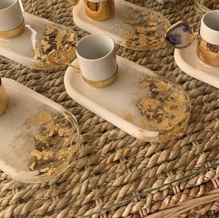 Decorative glass trays with gold leaf on a woven surface