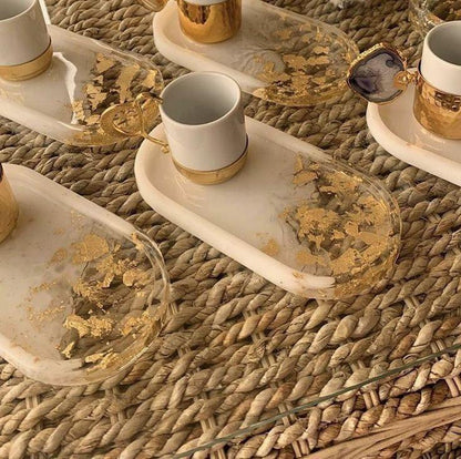 Decorative glass trays with gold leaf on a woven surface