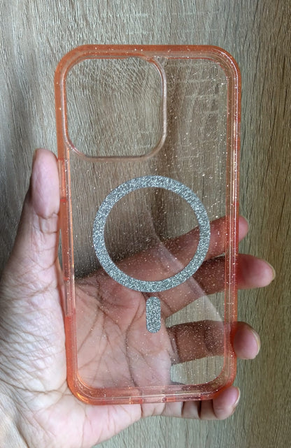 Clear phone case with a metallic ring holder held by a hand on a wooden surface